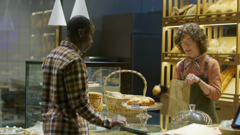customer purchasing bread at a bakery