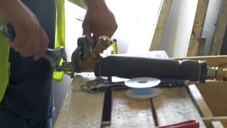 construction worker repairing the fire sprinkler pipe in a commercial building during renovation