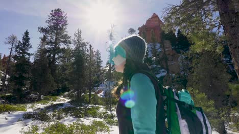 Girl-woman-hiking-with-red-rocks-formation-and-snow-near-Bryce-Canyon-in-southern-Utah-7