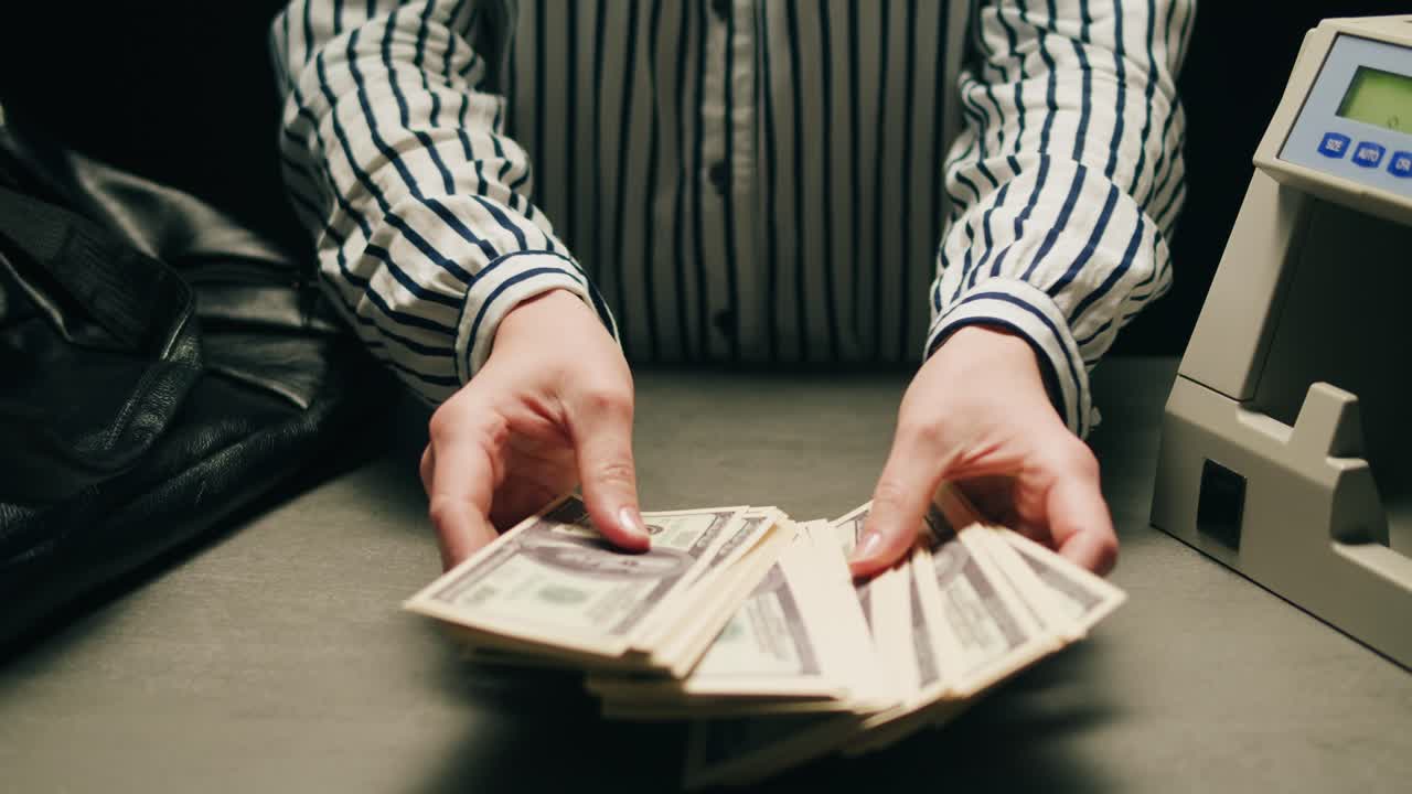 Specialised police officer Counting dollar banknotes in crime lab, conceptual image. High quality 4k footage