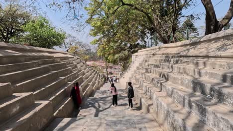 pashupatinath temple cremation complex in kathmandu, nepal. walking path surrounded by stairs leading downwards