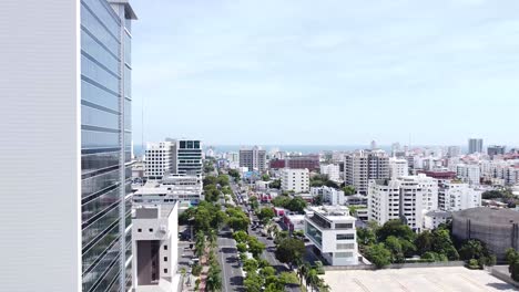 Drone-flying-above-the-street-between-modern-business-buildings