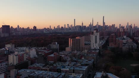 Stationary-aerial-shot-at-sunrise-looking-across-Central-Park-at-Midtown-Manhattan-skyline