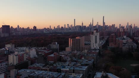 stationary aerial shot at sunrise looking across central park at midtown manhattan skyline