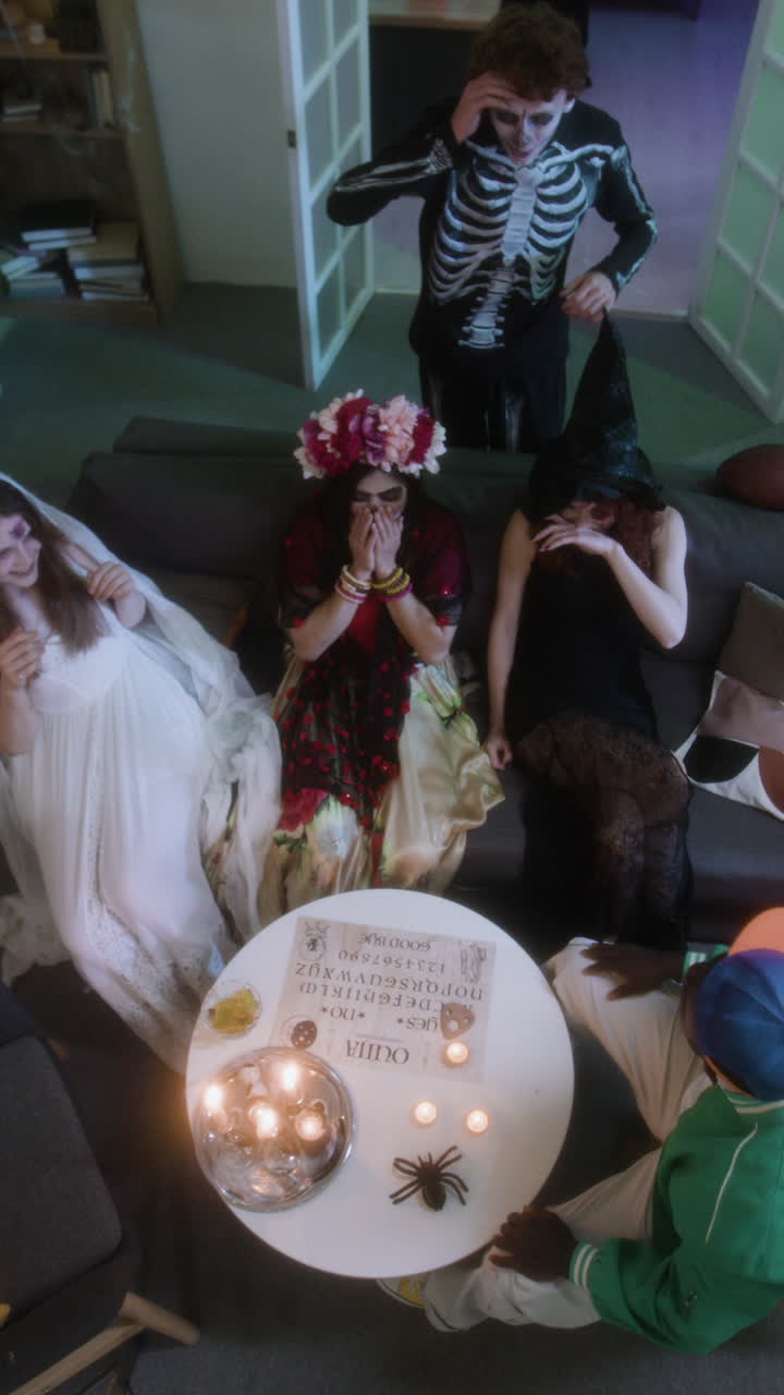 Halloween group in costumes using an Ouija board