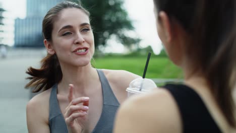 video of women in training clothes talking and drinking water