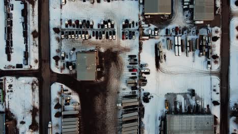 top-down aerial view of an outdoor warehouse covered with snow