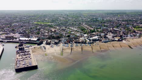 a slow aerial pan of the whitstable beach and harbour