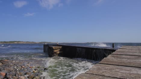 big waves crashing in to a pier located in the stockholm archipelago