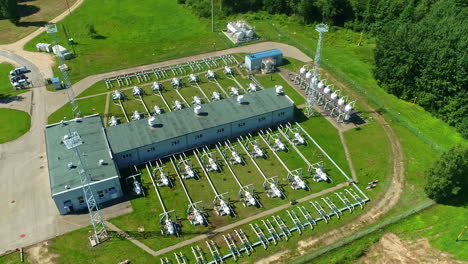 aerial view circling a natural gas pumping station on the sunny countryside