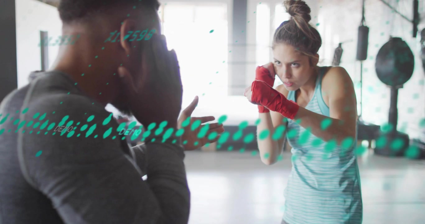 Vertical video: Coach holding hands boxer with wraps throwing jabs in gym gauging range, green dot