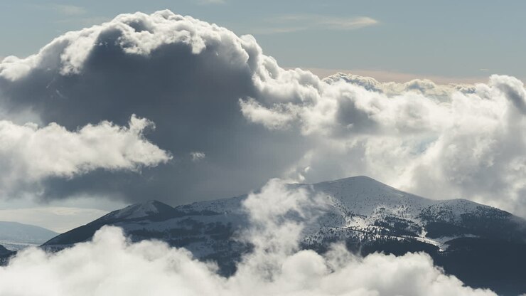 Timelapse Clouds over snow mountain winter panning right Kaimaktsalan Greece