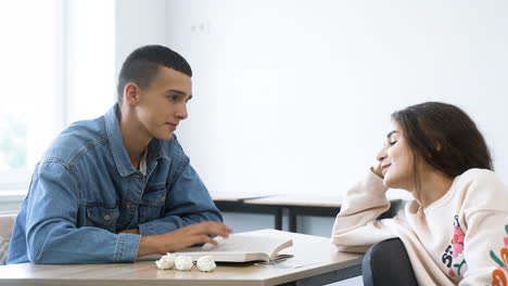 two friends talking in class