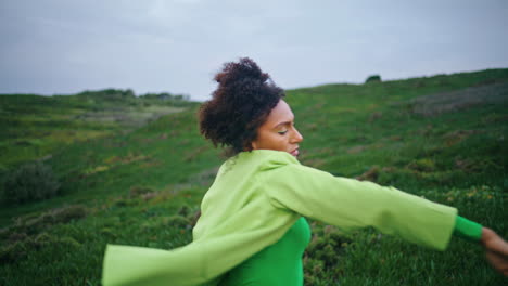 african girl performing modern dance on green field close up. performer dancing