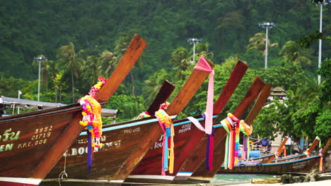 Telephoto-view-of-Thai-long-tail-boats-moored-on-beach-at-Koh-Phi-Phi,-Thailand