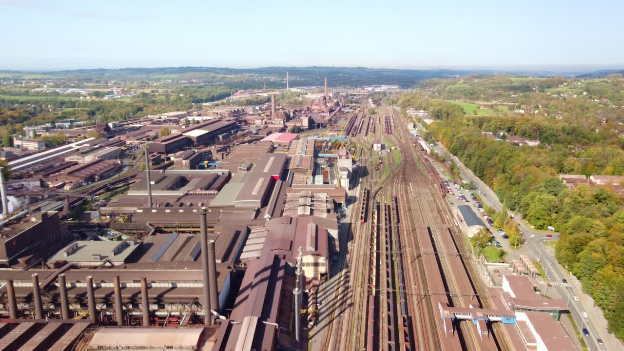Trinec steel factory with extensive industrial buildings, railway tracks, and green surroundings. Trinec, Czech Republic