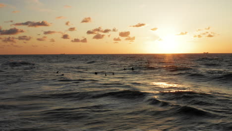 Surfers-in-front-of-the-touristic-town-Domburg-in-the-Netherlands-during-sunset