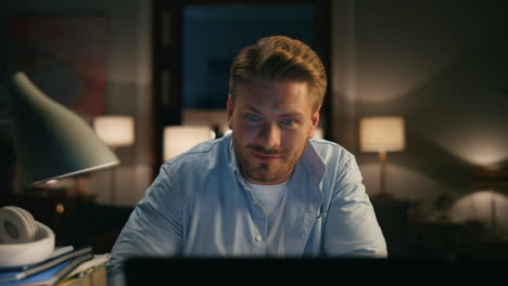 Smart-man-talking-videocall-computer-at-workplace-closeup.-Guy-waving-goodbye