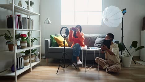couple filming a makeup tutorial video at home