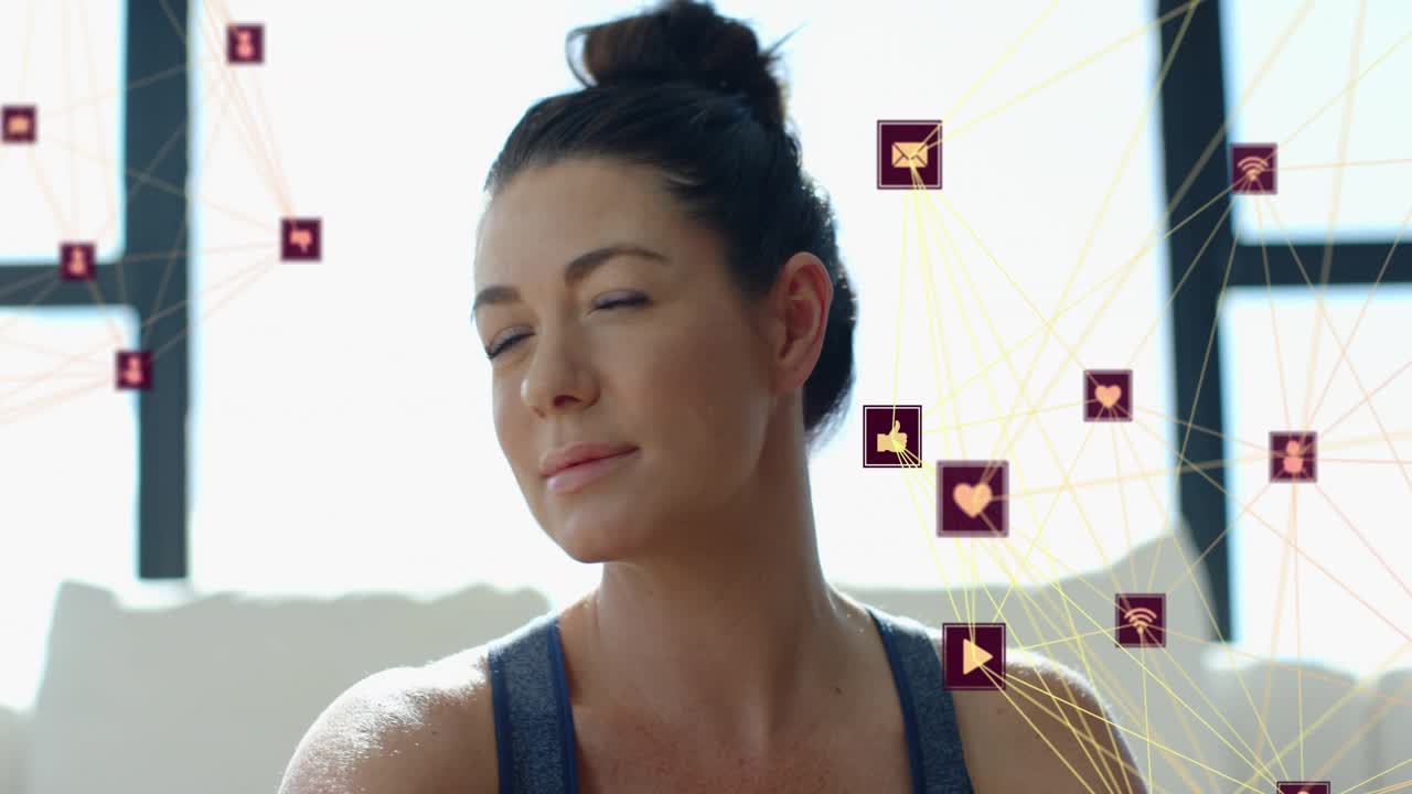 Camera pulling back woman sitting touching navel then turning head animated health icons on right