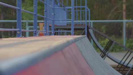 camera focuses on young man riding legs on skateboard