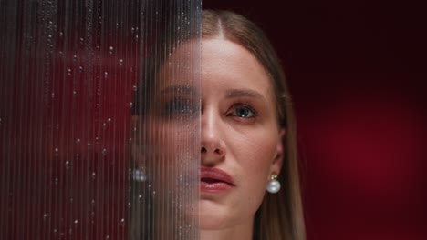 woman behind a water-stained screen