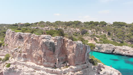 Aerial-view,-the-couple-on-top-of-the-rock