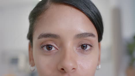 Portrait-of-happy-biracial-female-nurse-looking-at-camera-at-hospital,-in-slow-motion