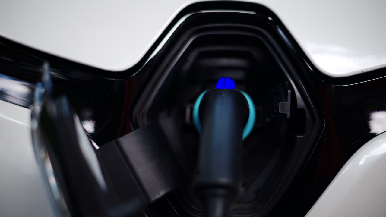 Close up of a white electric car charging