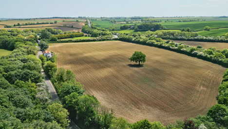 A-summer-British-park-captured-from-the-sky-by-a-drone,-featuring-a-winding-stream,-inviting-picnic-spots,-and-a-wooded-tourist-magnet—Hubbard's-Hills,-a-natural-gem-near-Louth,-Lincolnshire