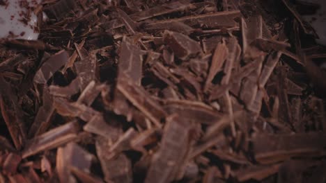 closeup view of adding dark chocolate to coconut milk, baking a chocolate oat cake - steady shot