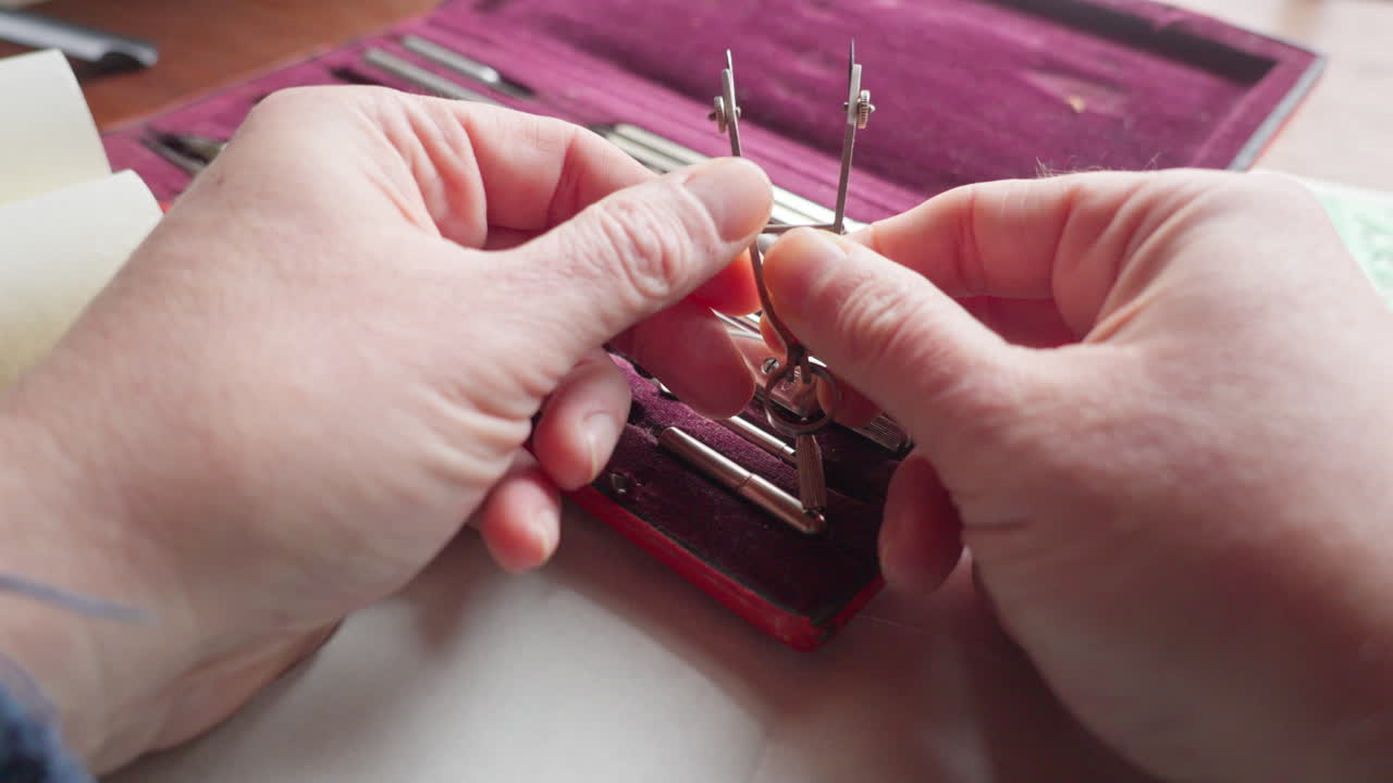 POV shot of hands adjusting a compass screw, highlighting calibration, control, and the importance of precision in technical design