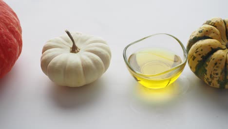 pumpkin oil with white and green pumpkins