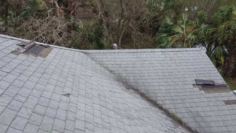 water damage to the house roof from strong hurricane storm winds pending insurance claim