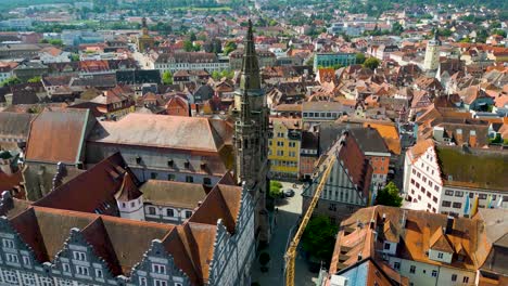 4k aerial drone video of the historic half-timbered homes around the kirche st. gumbertus church in downtown ansbach, germany