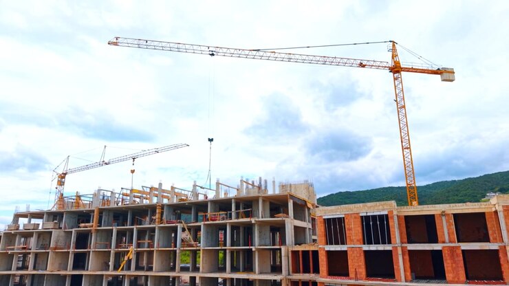 Panoramic view of multi-story residential block under construction. Panoramic wide shot of multiple residential apartment buildings during the concrete framework phase.
