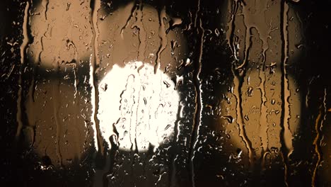 Various-shots-and-camera-movement-of-detailed-rain-drops-falling-on-window