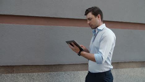 close up view of businessman walking with tablet