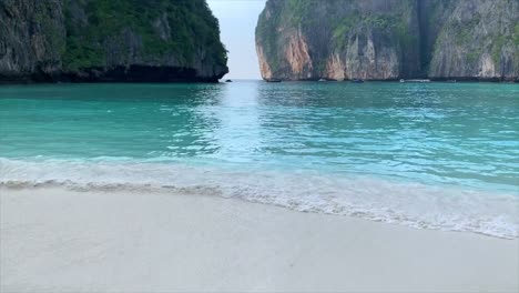 the beach in thailand with limestone rocks in the scene