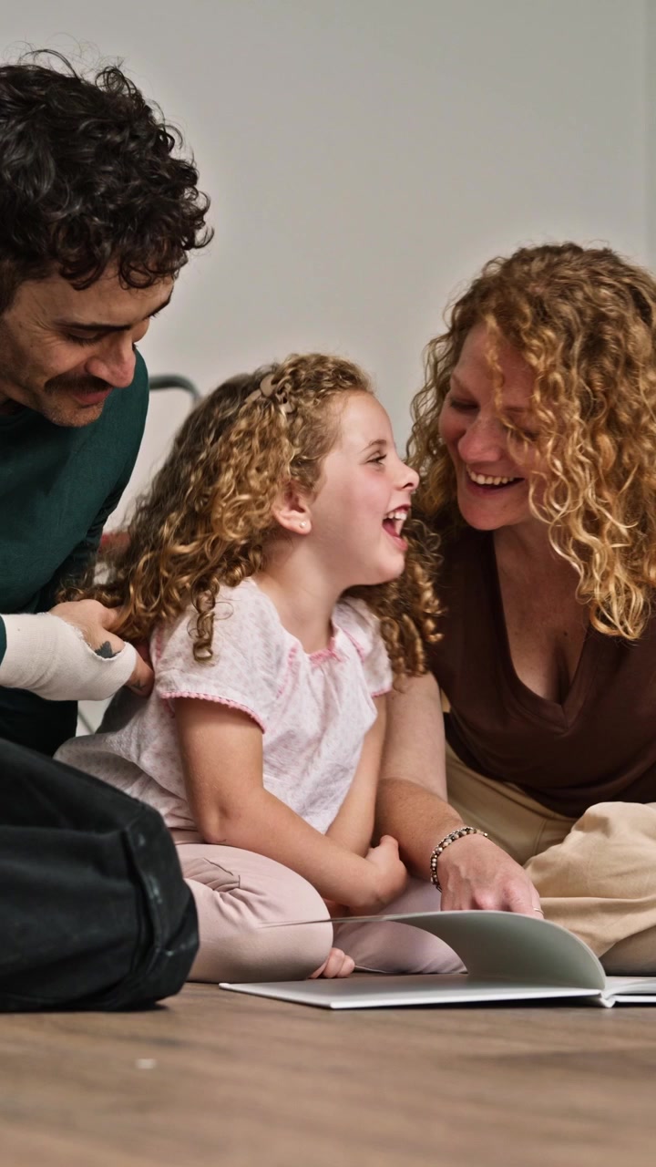 Family Reading a Book Together on the Floor