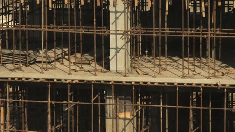 scaffolding tubes holding floors at construction building