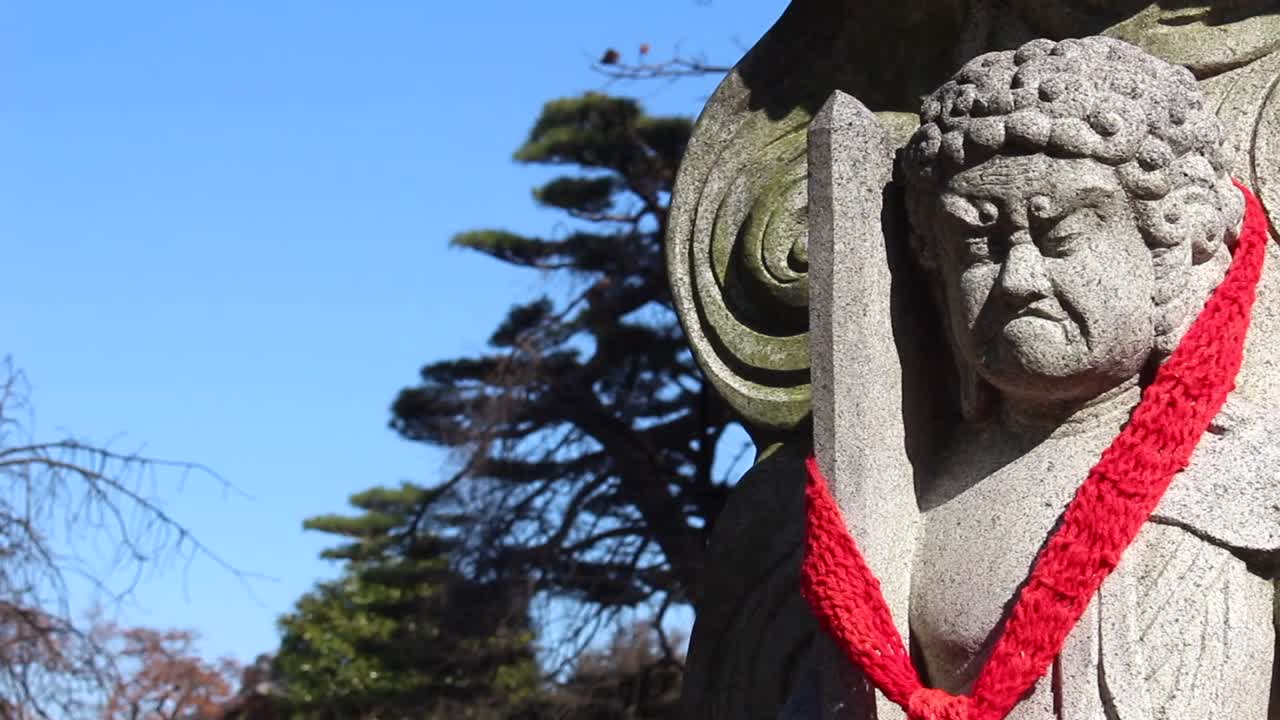 In general each Buddha in the temples of Tokyo have different faces that mark different personalities, in this case a Buddha with a sword and the face of a demon