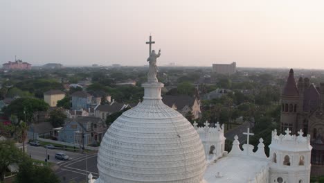 Drone-view-of-Statue-on-top-of-the-Sacred-Heart-Catholic-Church-in-Galveston,-Texas