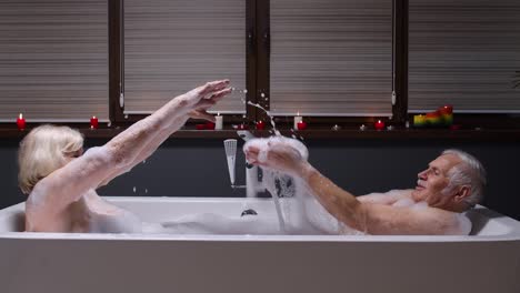 elderly couple having fun in a romantic bubble bath