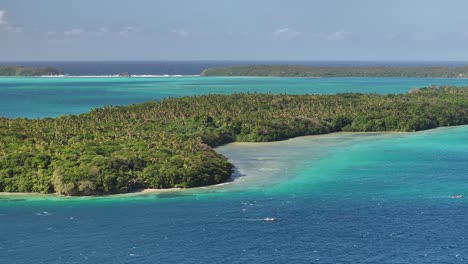 tropical lush forest island of vava'u surrounded by pacific water in tonga. aerial, wide shot