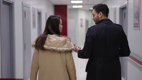 people walking in a hospital hallway
