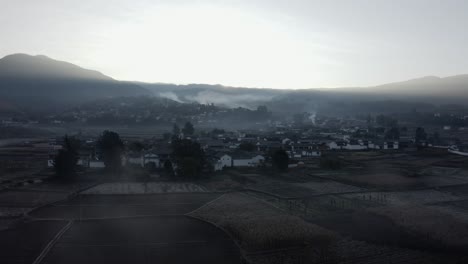 misty autumnal morning over remote chinese village, yunnan province, aerial view