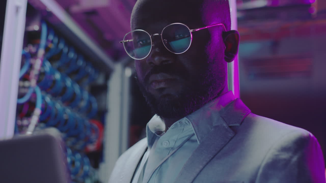 African American IT Engineer Working on Laptop