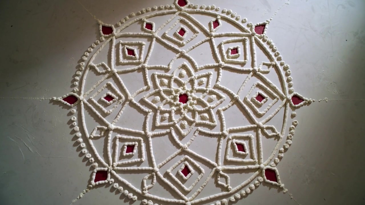 Sliding camera moving closer in room, slider starting to show beadwork and red accents on rangoli