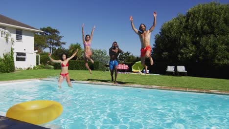 diverse group of friends having jumping into a swimming pool